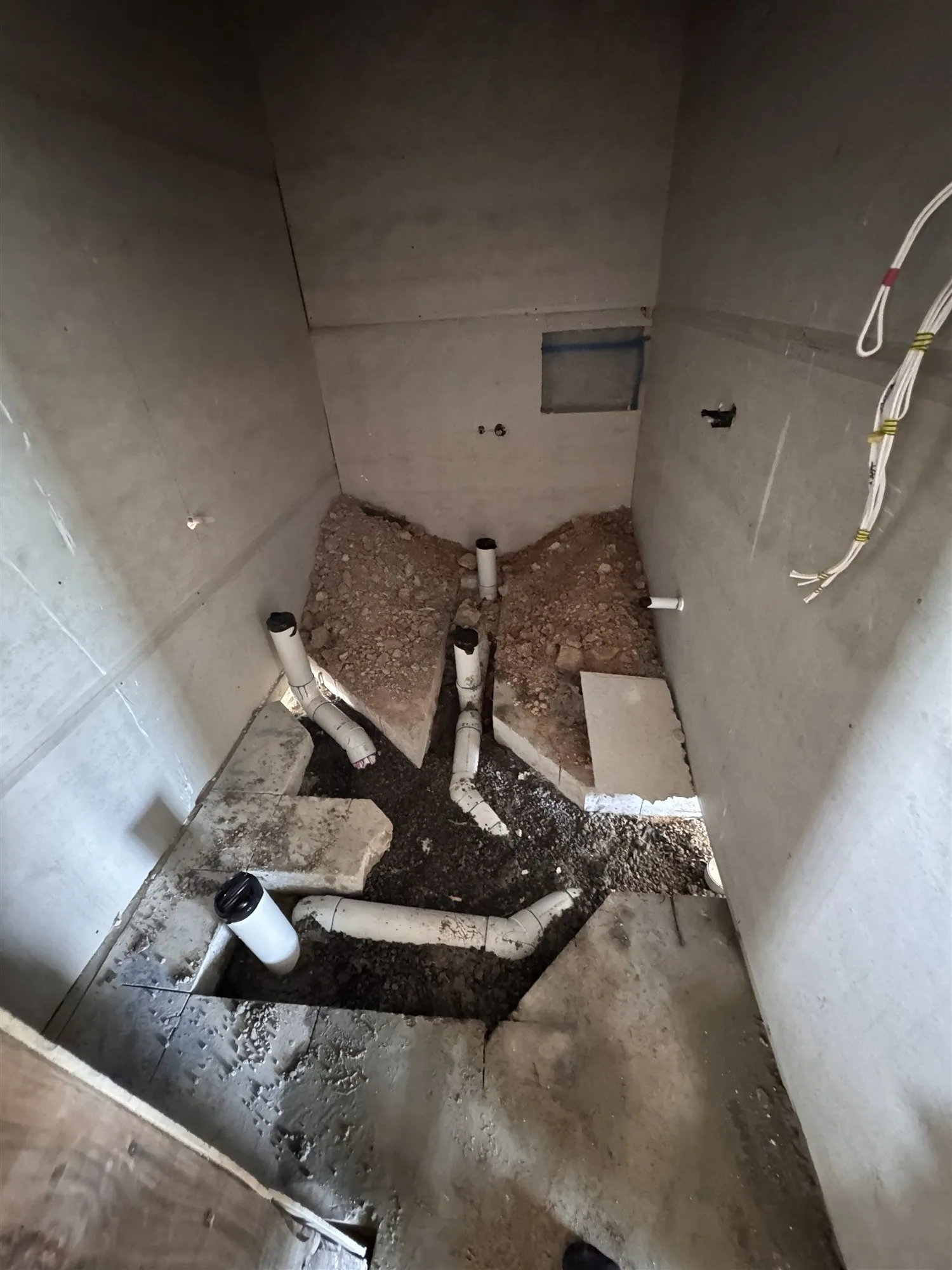 New PVC drainage and risers in the floor of a relocated bathroom