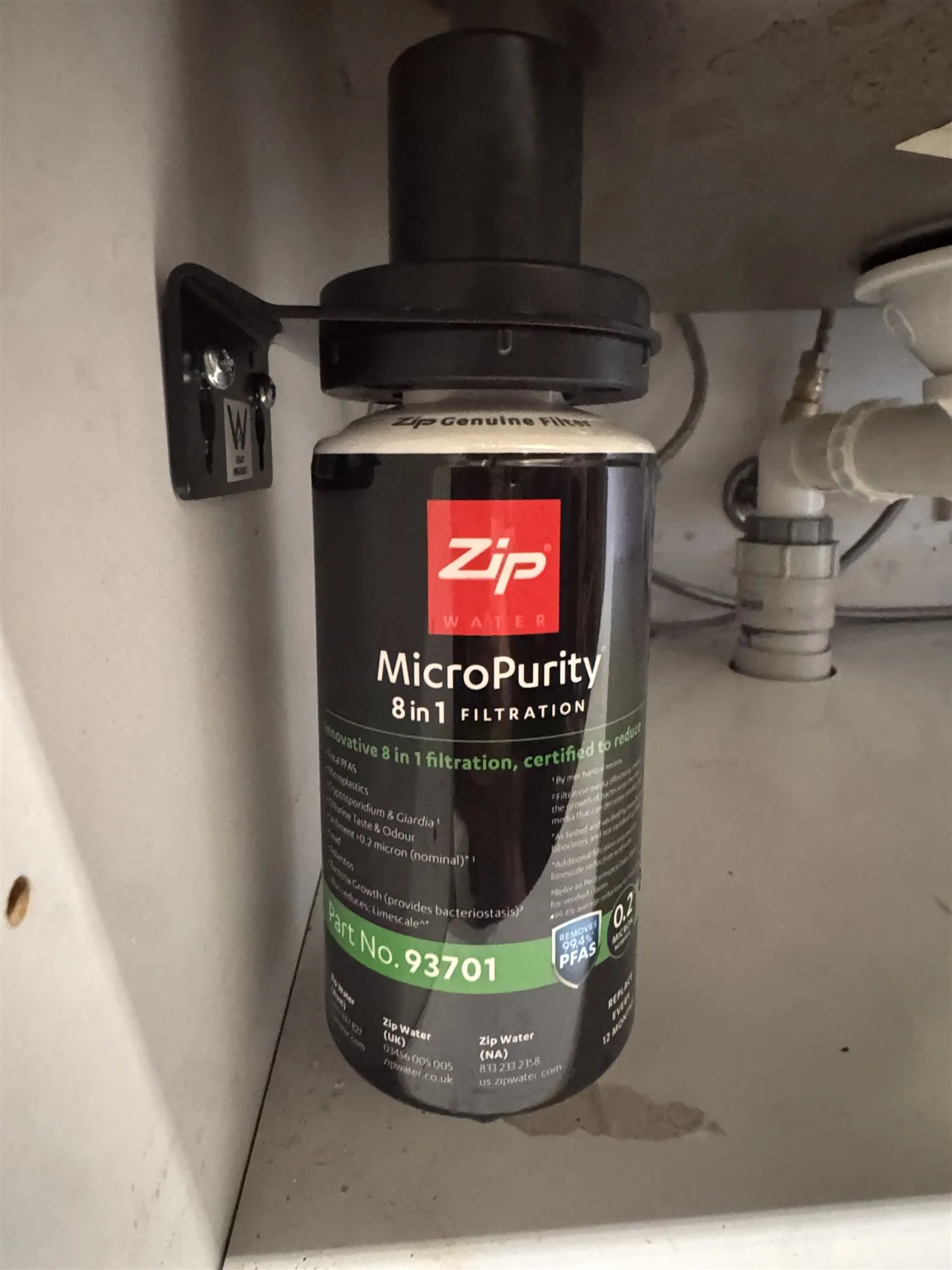 Zip MicroPurity filter mounted on a bracket inside the cabinet under the sink