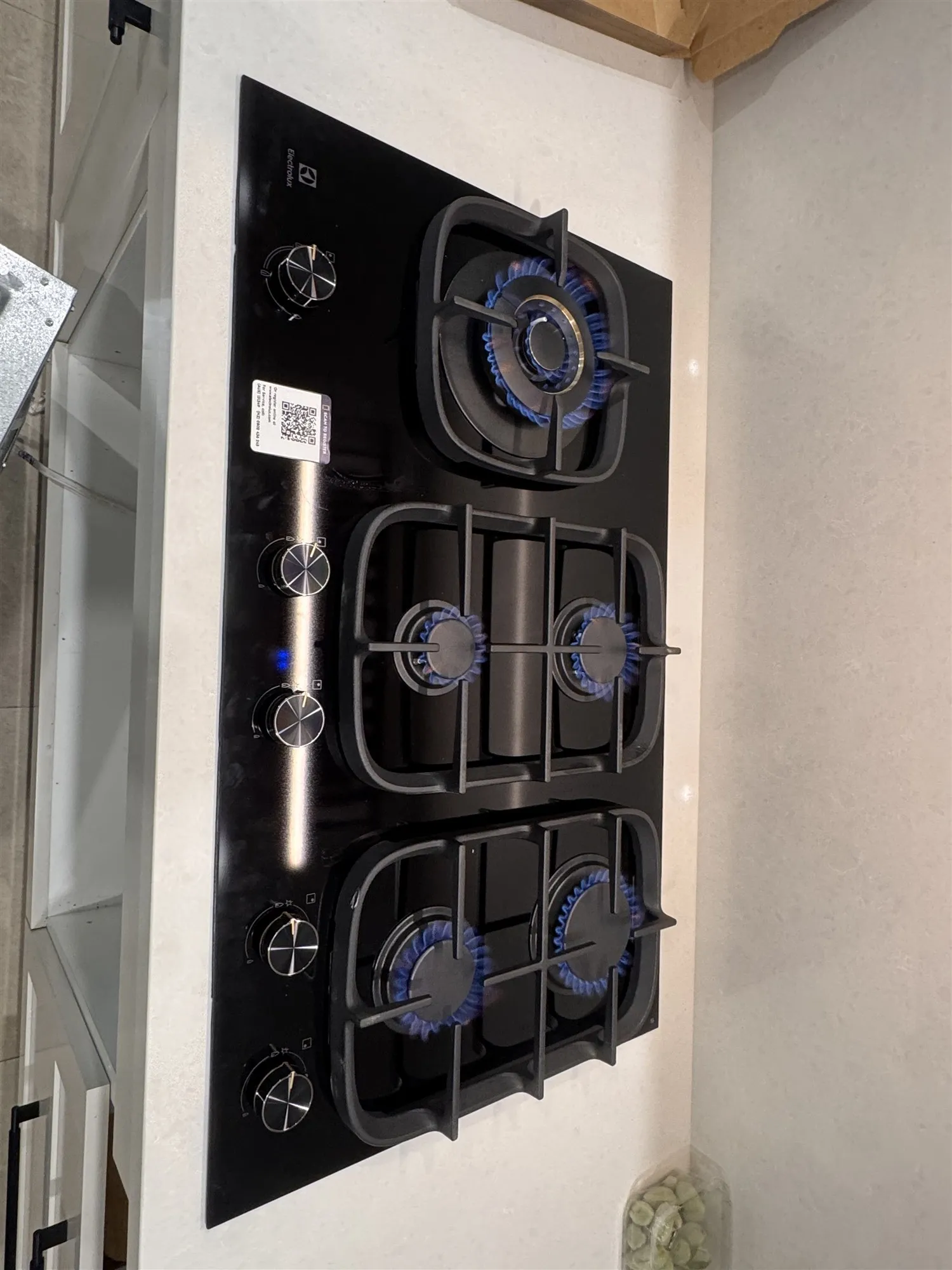 Top view of the new gas cooktop with the burners lit after testing