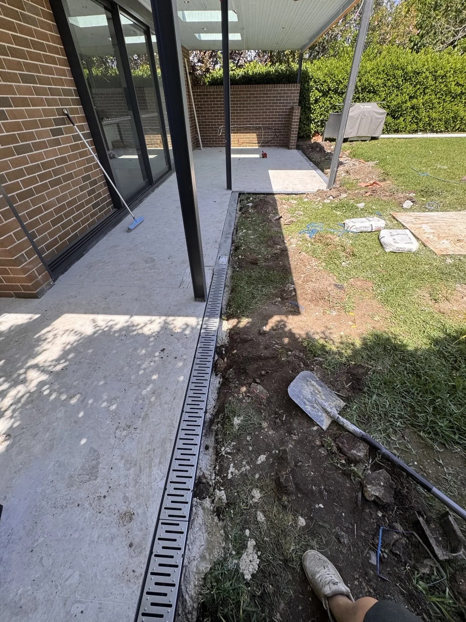 New grated strip drain installed along the edge of the outdoor area