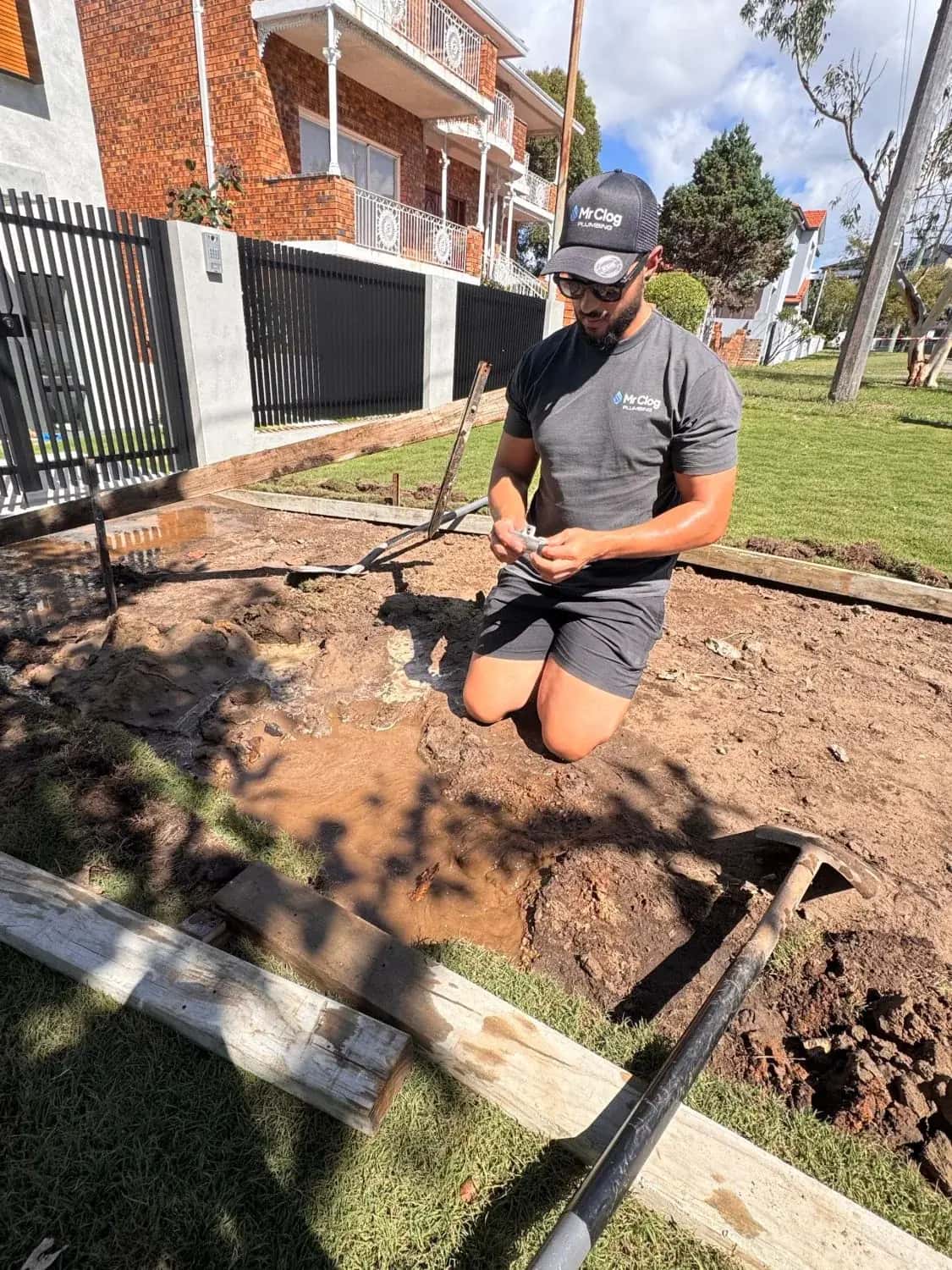 Mr. Clog plumber excavating a burst water main in a Sydney front yard